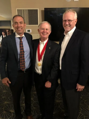 Bryce is congratulated by Bill Cutts and Ray Greer